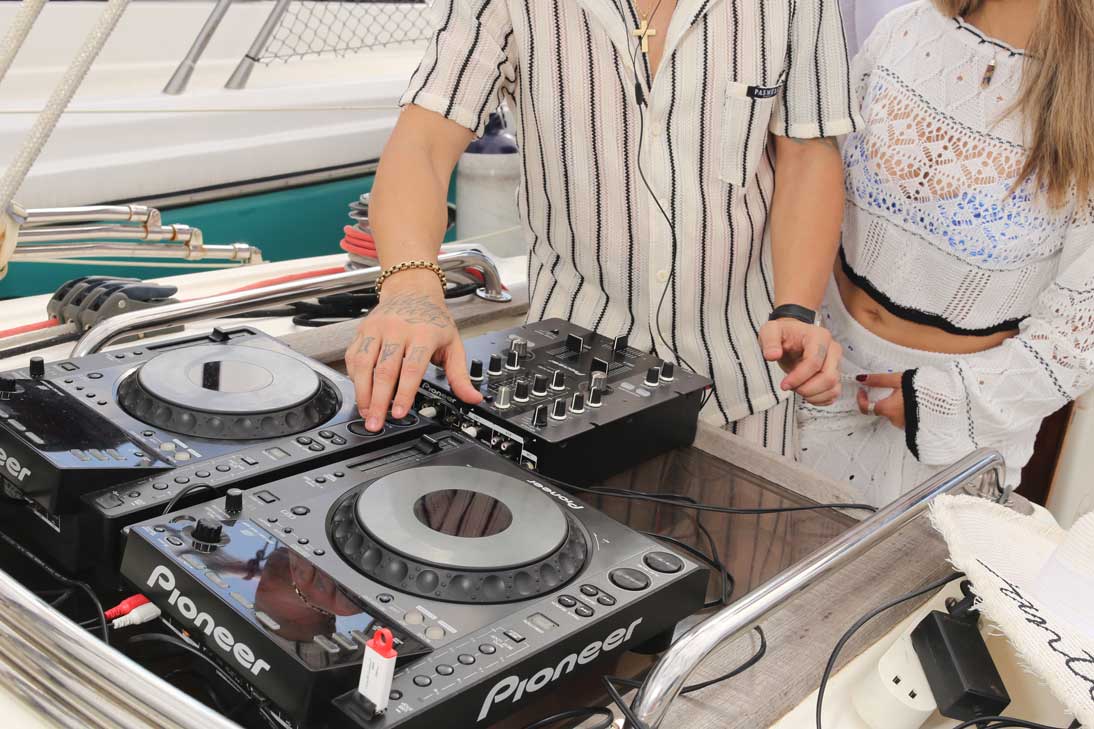 A person steering a sailboat on the ocean